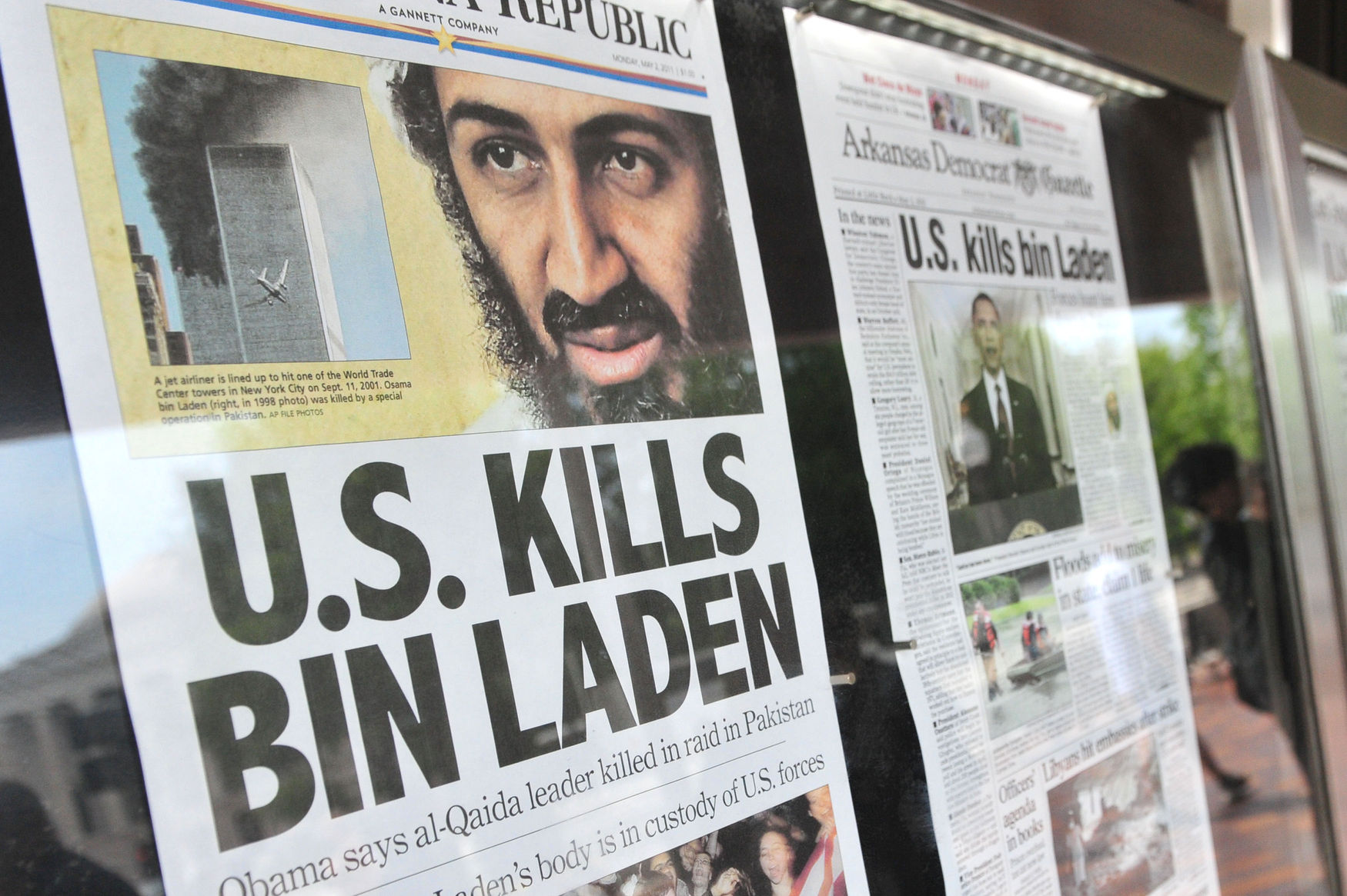 People look at newspaper headlines announcing the death of Osama Bin Laden in Washington