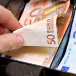 hand taking euros in cash register 640x379
