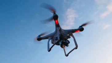 drone flying under white sky